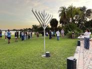 The display menorah, unlit, with the crowd in the background